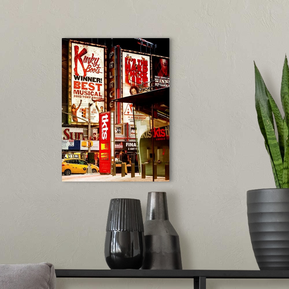A modern room featuring A photograph of Broadway at night, New York city.