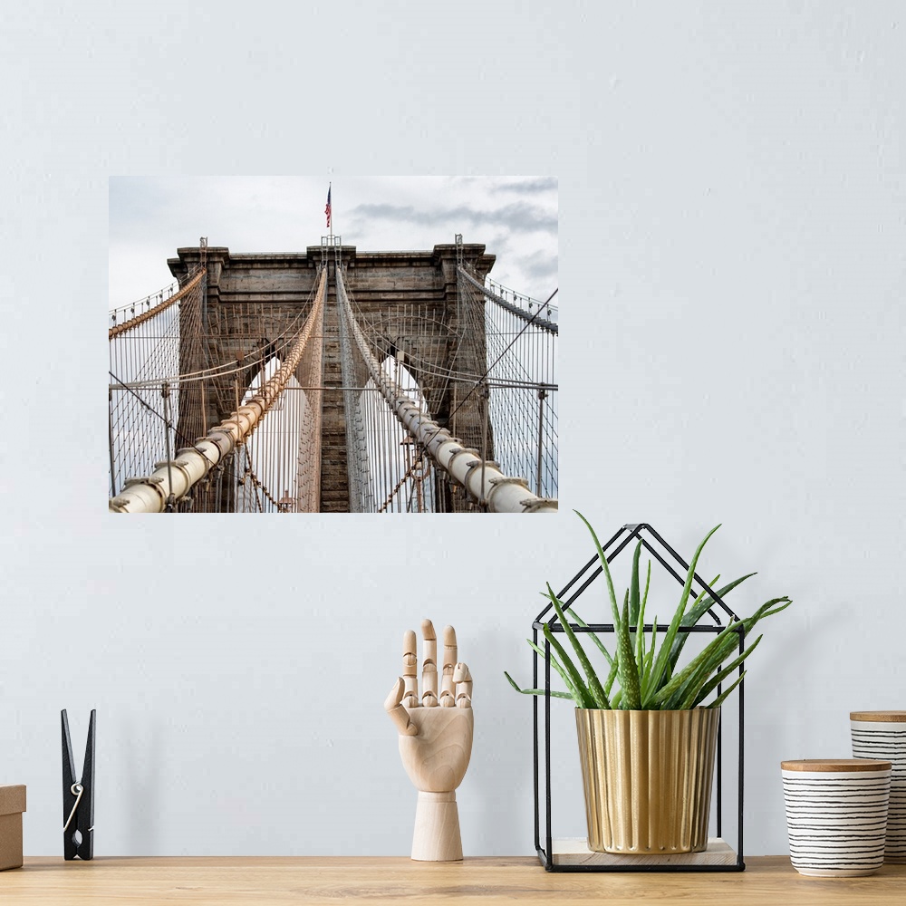 A bohemian room featuring A photograph of the Brooklyn bridge upper section.