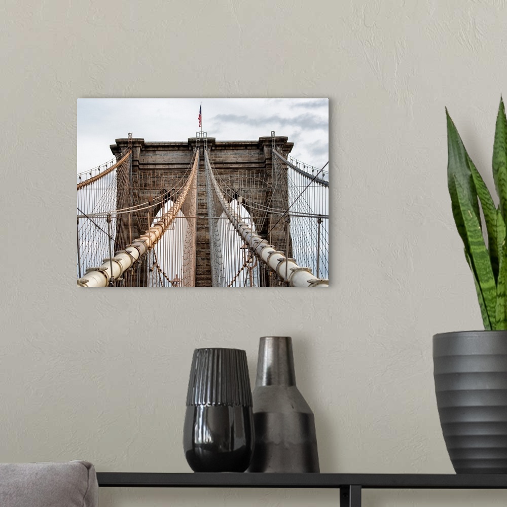 A modern room featuring A photograph of the Brooklyn bridge upper section.