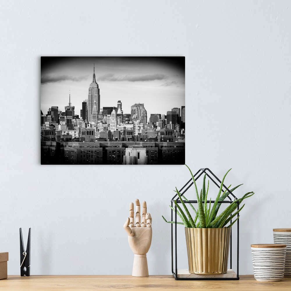 A bohemian room featuring A black and white photograph of the Empire state building standing tall in New York city.