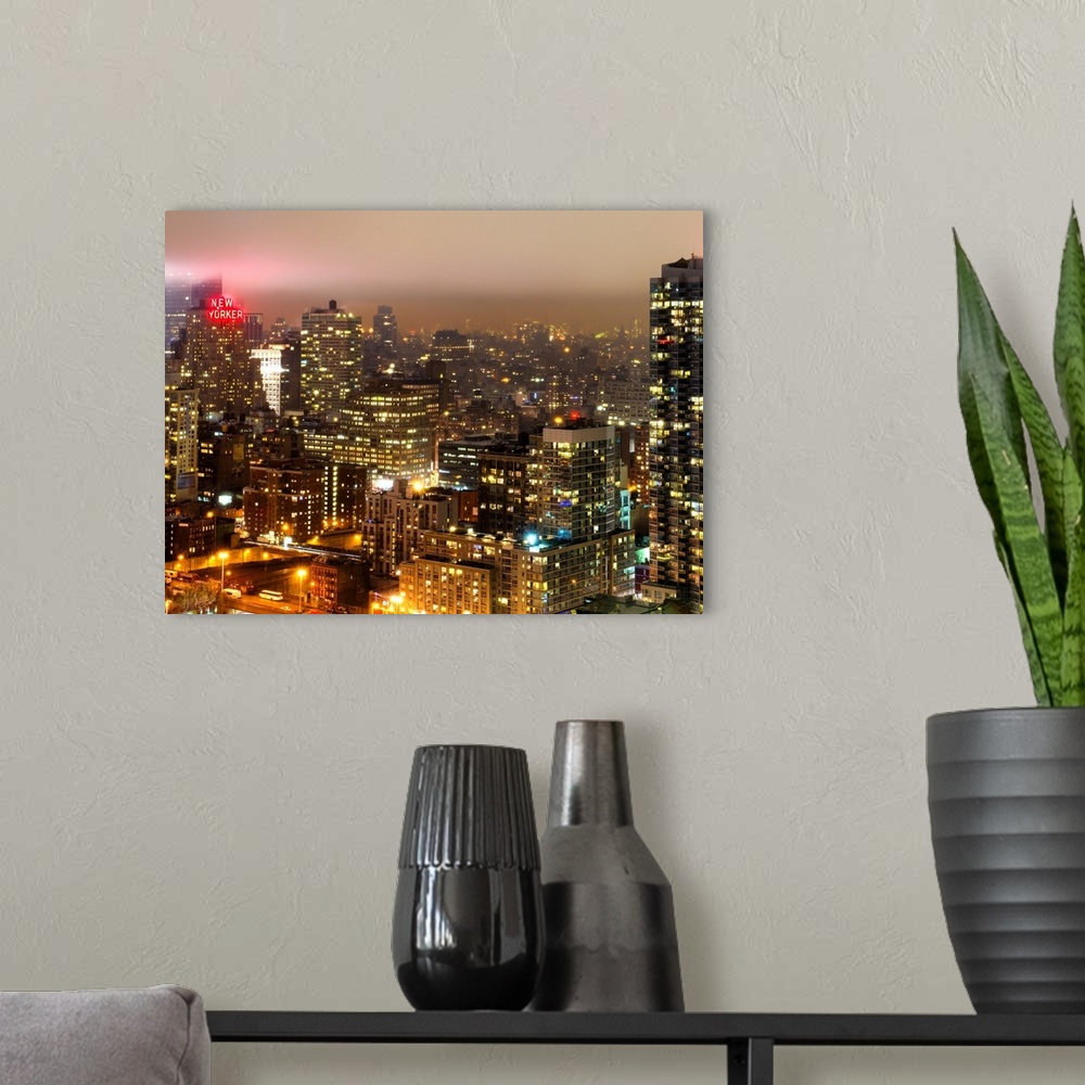 A modern room featuring New York city at night under a blanket of thick fog.