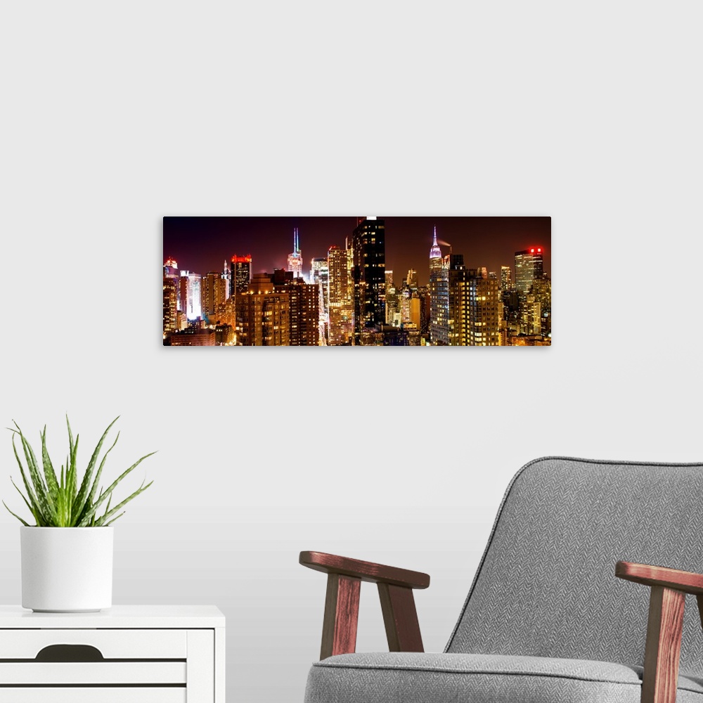A modern room featuring A photograph of New York city at night, with neon light shining bright.