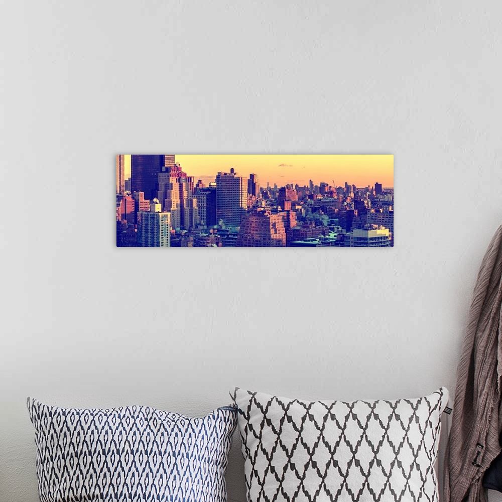 A bohemian room featuring A photograph of New York city architecture at sunset.