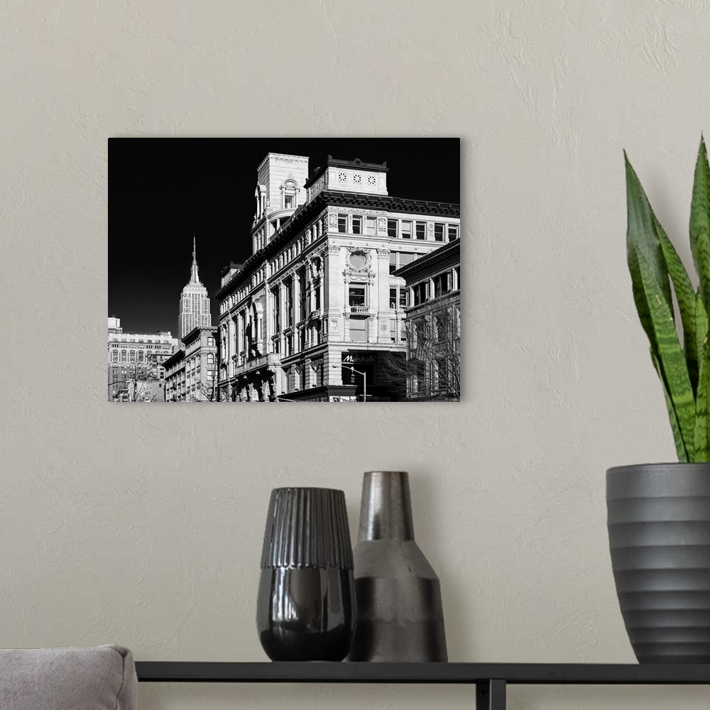 A modern room featuring A black and white photograph of the Empire state building standing tall in NYC.