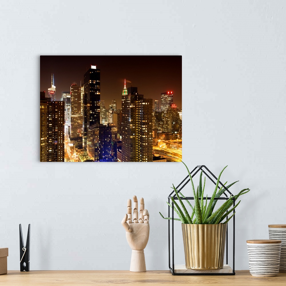 A bohemian room featuring A fine art photograph of New York city's Manhattan lit up at night.