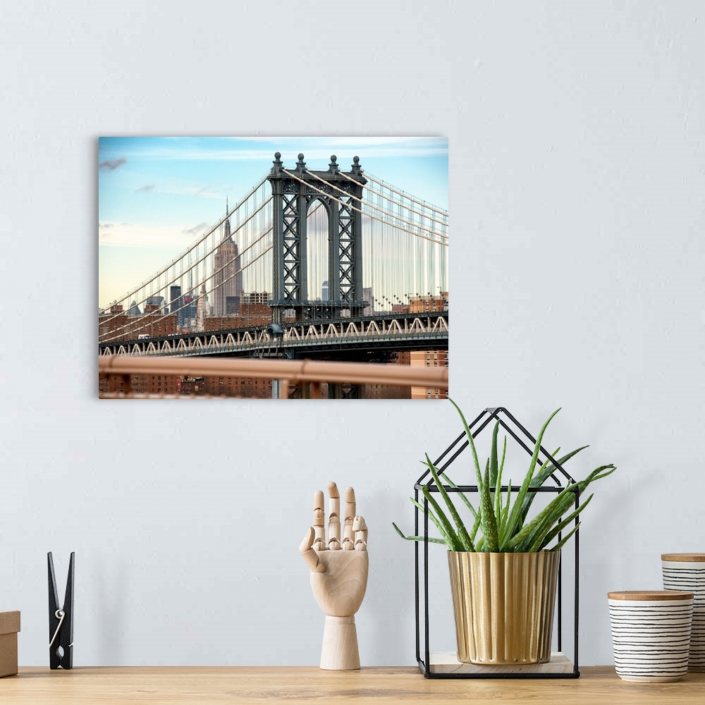 A bohemian room featuring A photograph of the Manhattan bridge, with the Empire state building in the background.