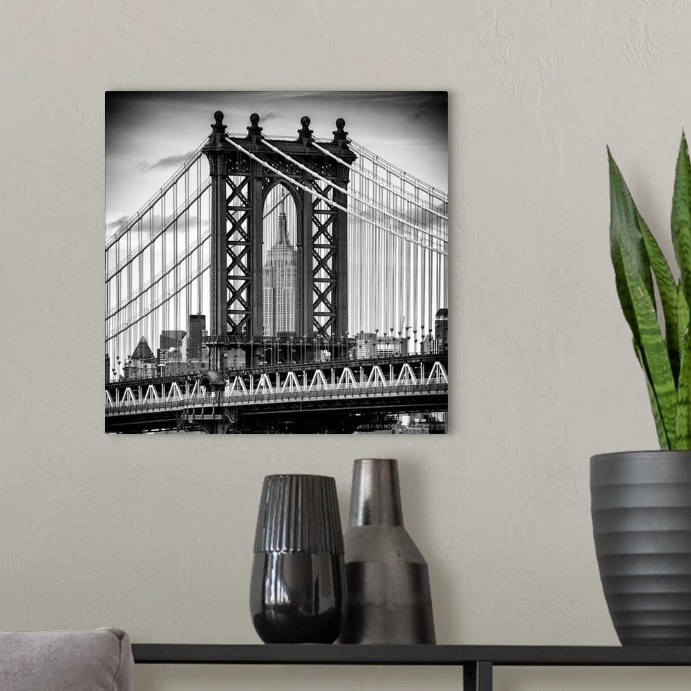 A modern room featuring A black and white photograph of the Manhattan bridge, with the Empire state building in the backg...