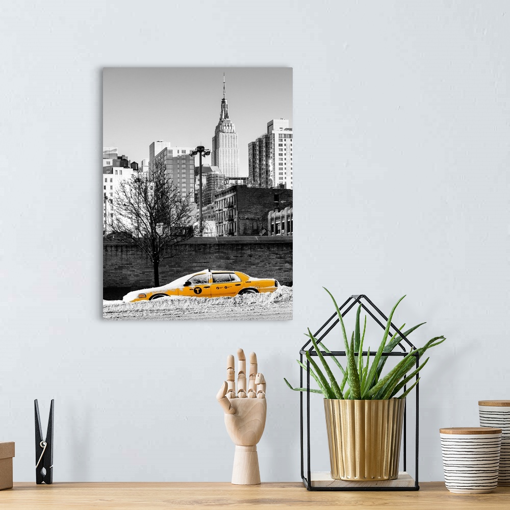 A bohemian room featuring A photograph of a yellow taxi cab in Manhattan in winter.