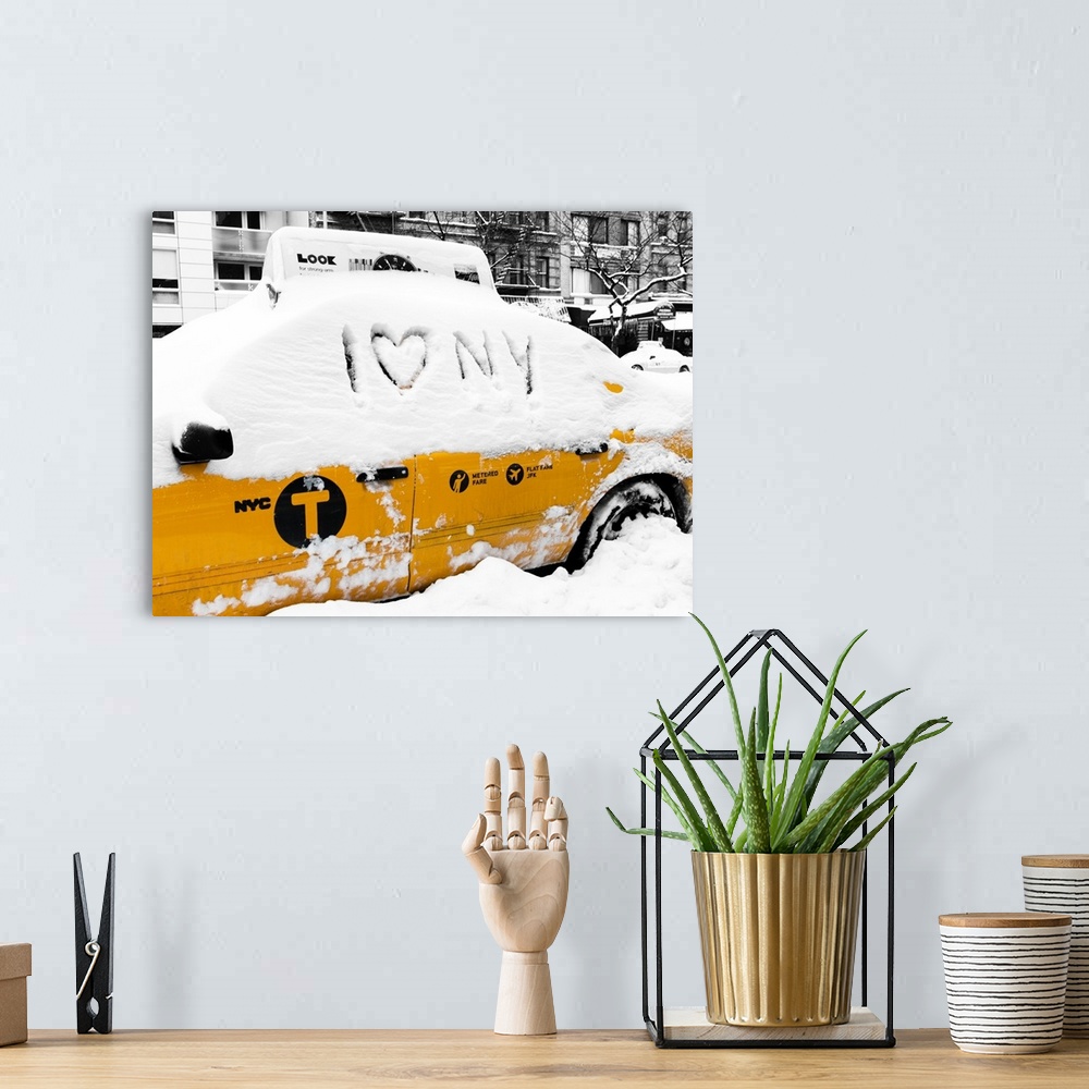 A bohemian room featuring A photograph of a yellow taxi cab in Manhattan in winter.