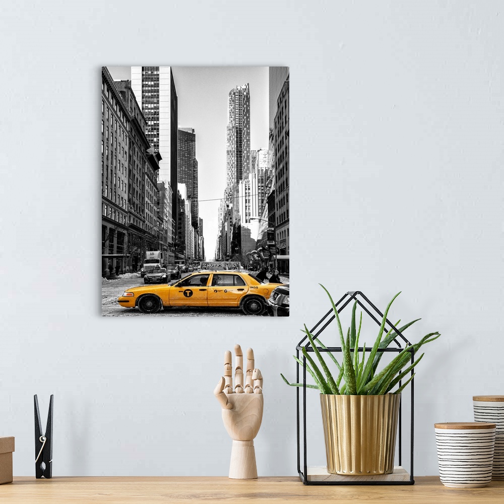 A bohemian room featuring A black and white photograph of New York city with bright yellow colored taxis on the road.