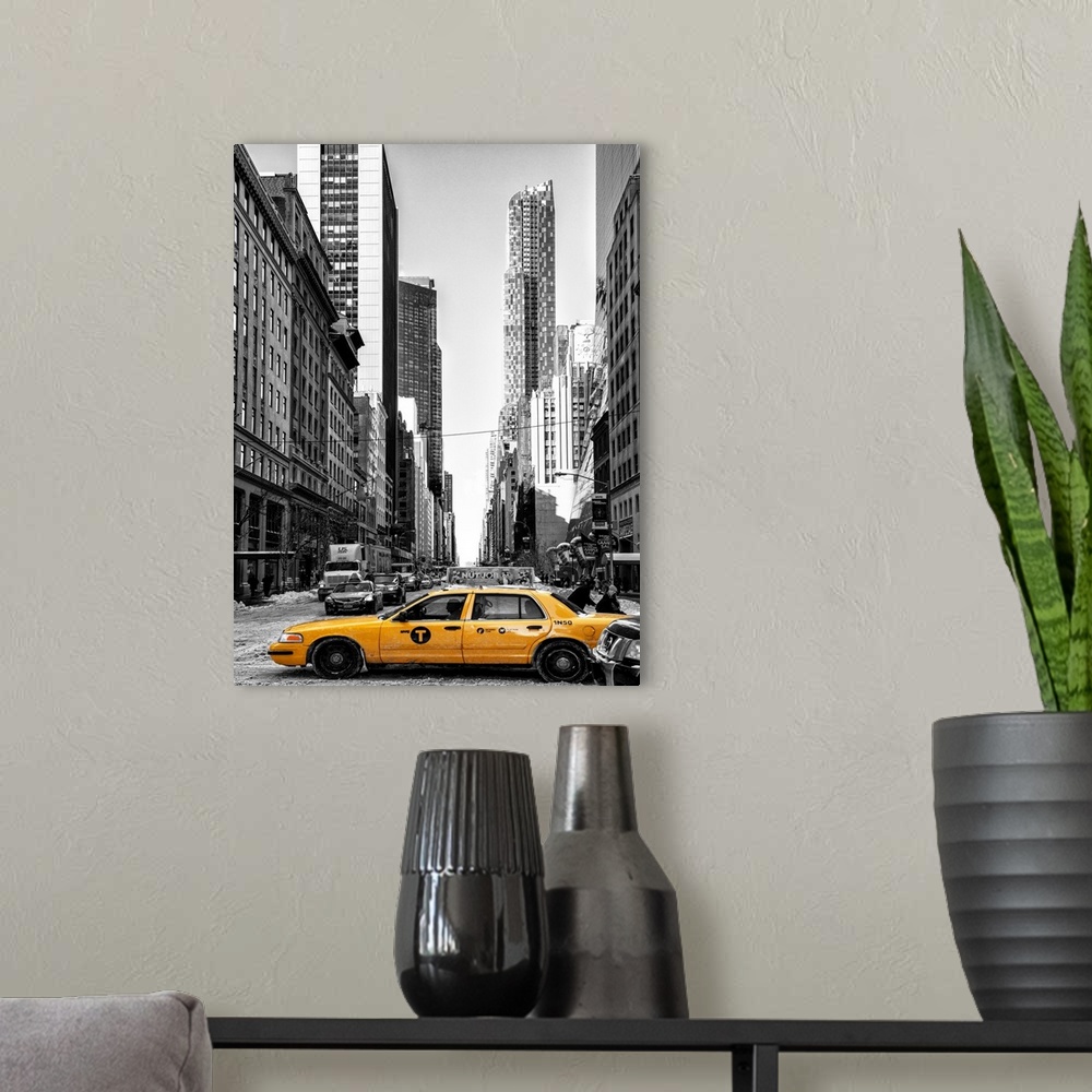 A modern room featuring A black and white photograph of New York city with bright yellow colored taxis on the road.