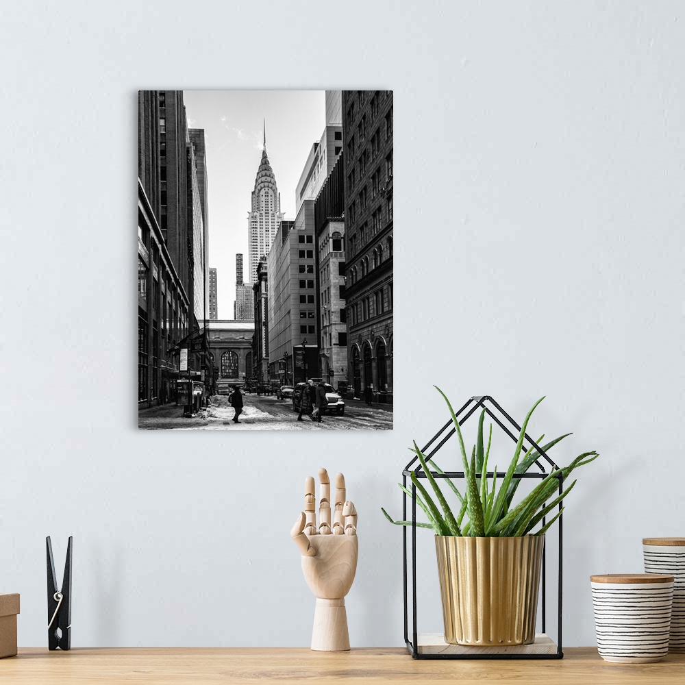 A bohemian room featuring A black and white photograph of the Chrysler building standing tall in NYC, seen from street level.