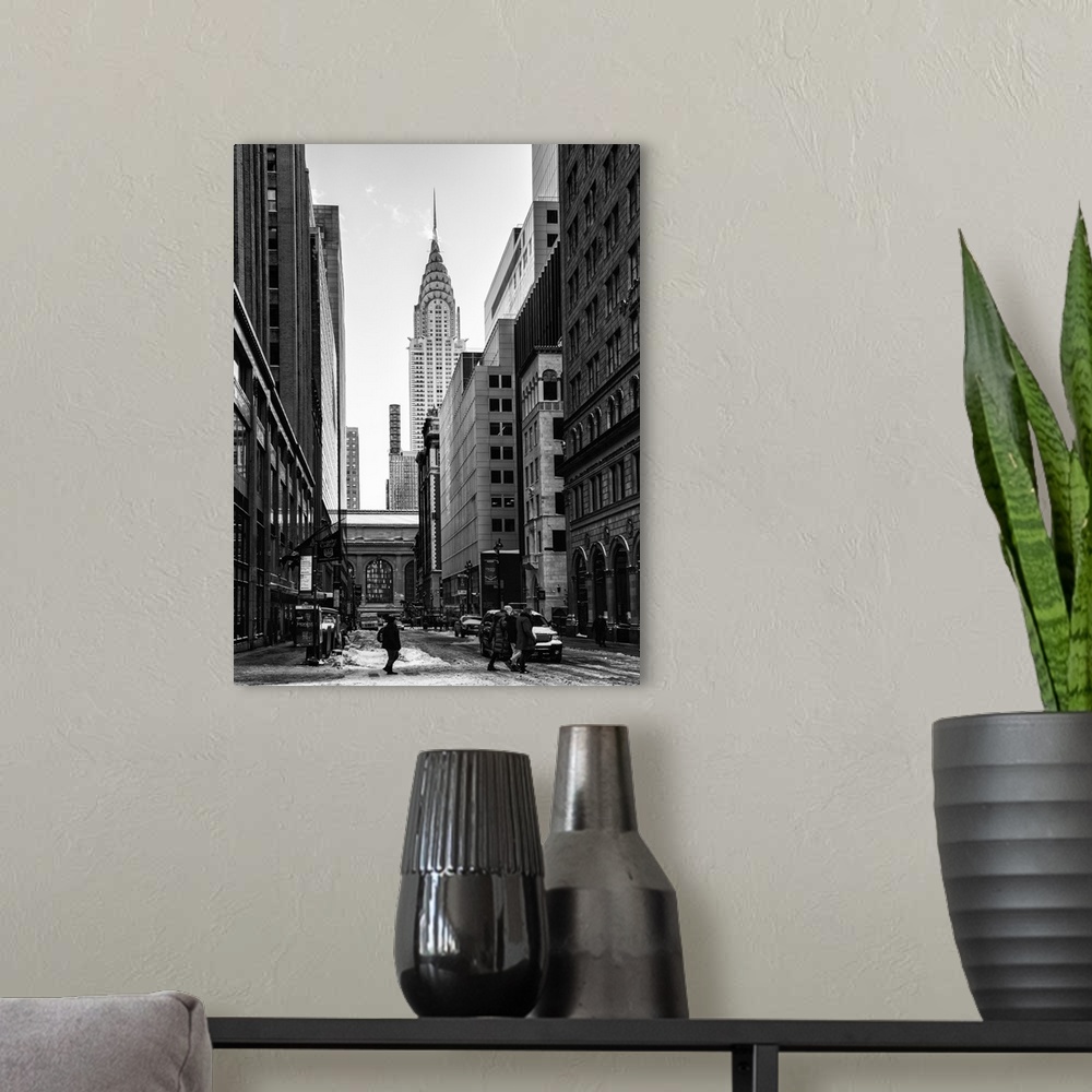 A modern room featuring A black and white photograph of the Chrysler building standing tall in NYC, seen from street level.