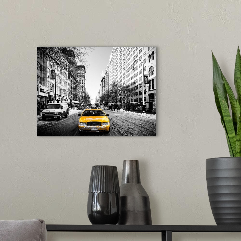 A modern room featuring A black and white photograph of New York city with bright yellow colored taxis on the road.