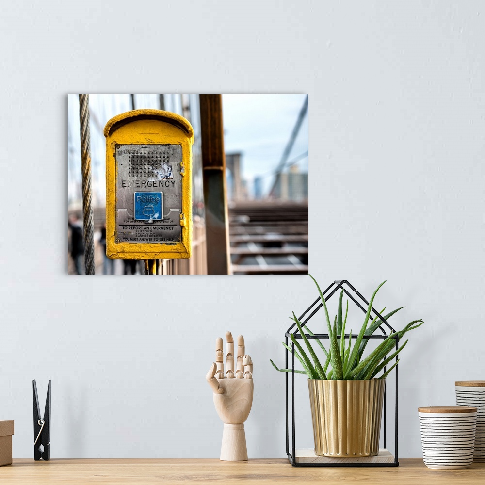 A bohemian room featuring A photograph of New York city with a bright yellow colored police box in the foreground.