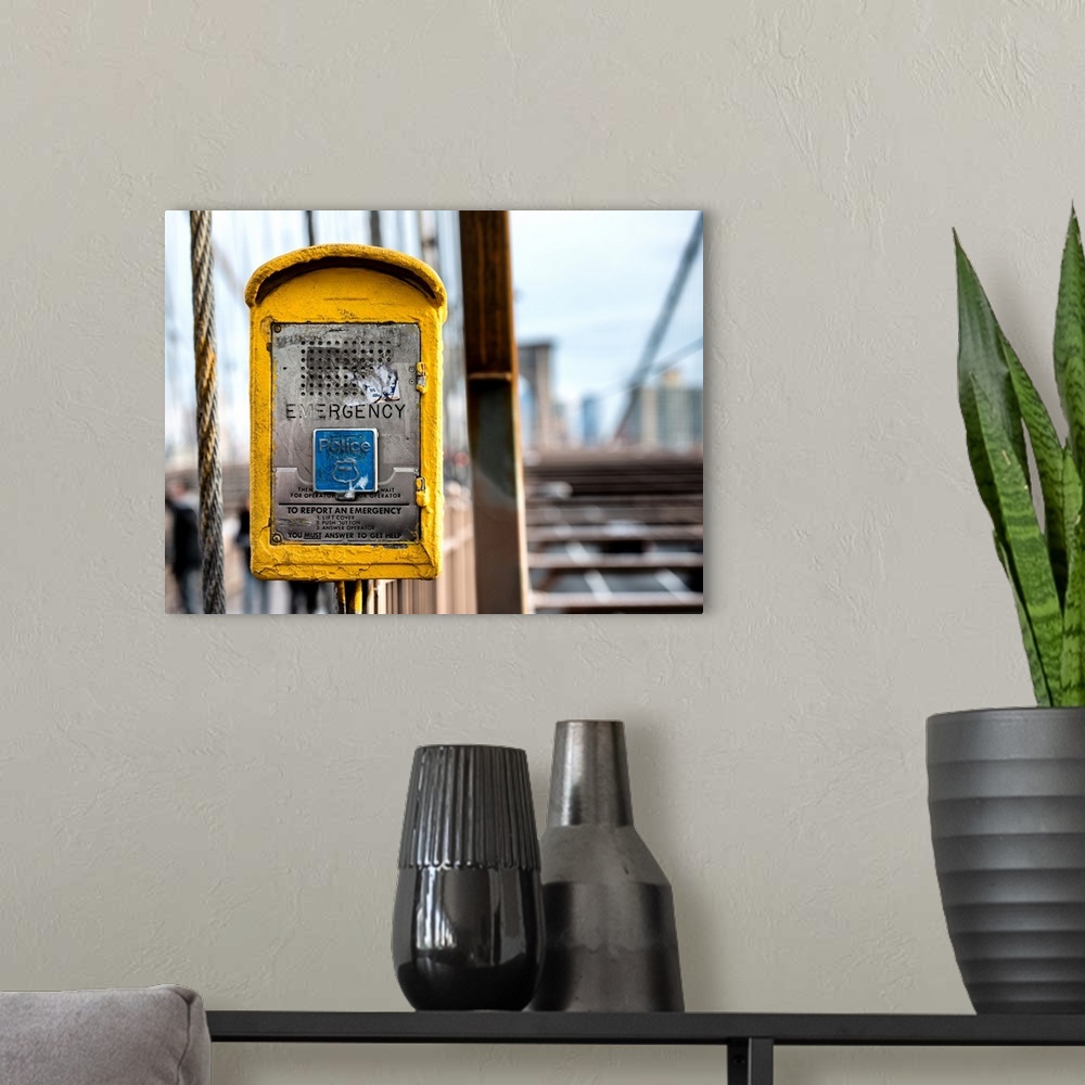 A modern room featuring A photograph of New York city with a bright yellow colored police box in the foreground.