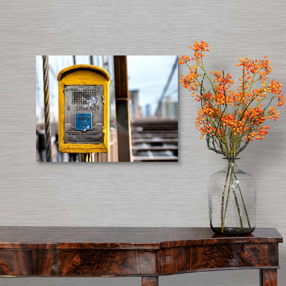 A traditional room featuring A photograph of New York city with a bright yellow colored police box in the foreground.