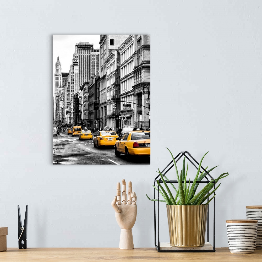 A bohemian room featuring A black and white photograph of New York city with bright yellow colored taxis on the road.