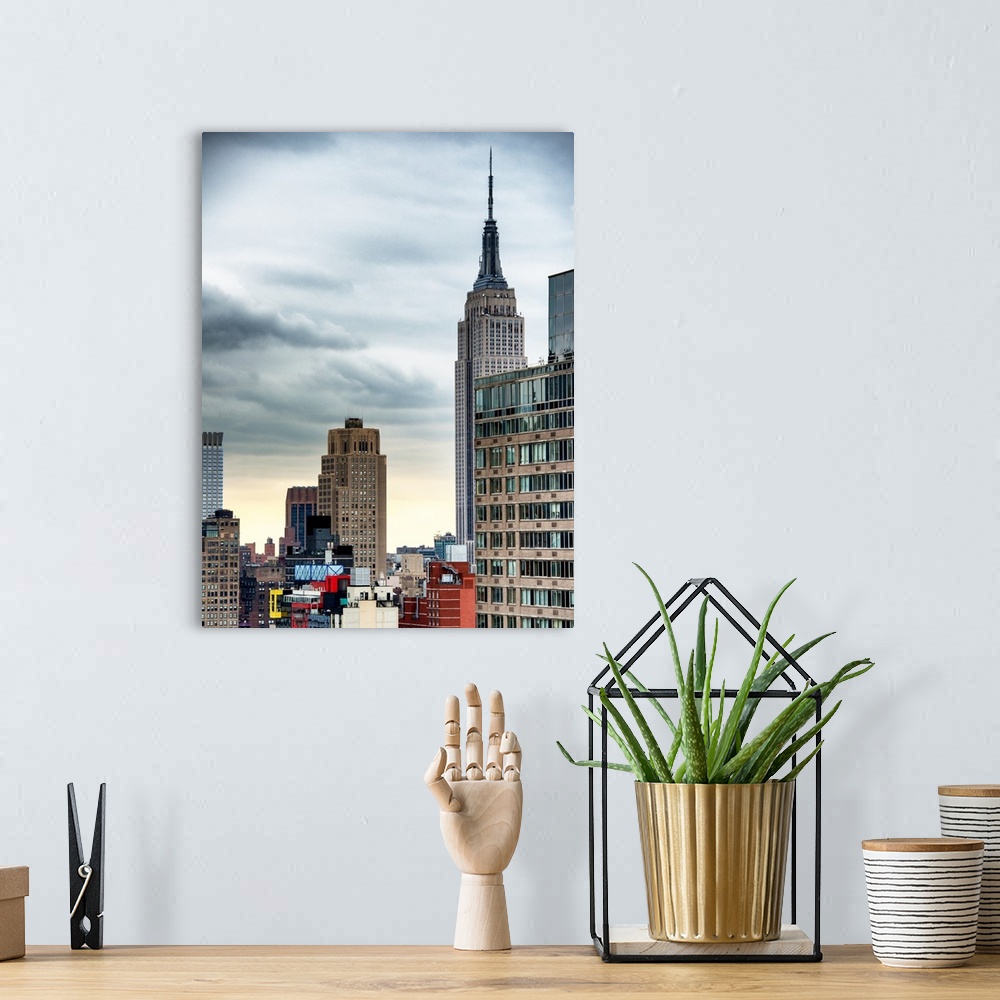 A bohemian room featuring A photograph of the Empire state building standing tall in New York city.