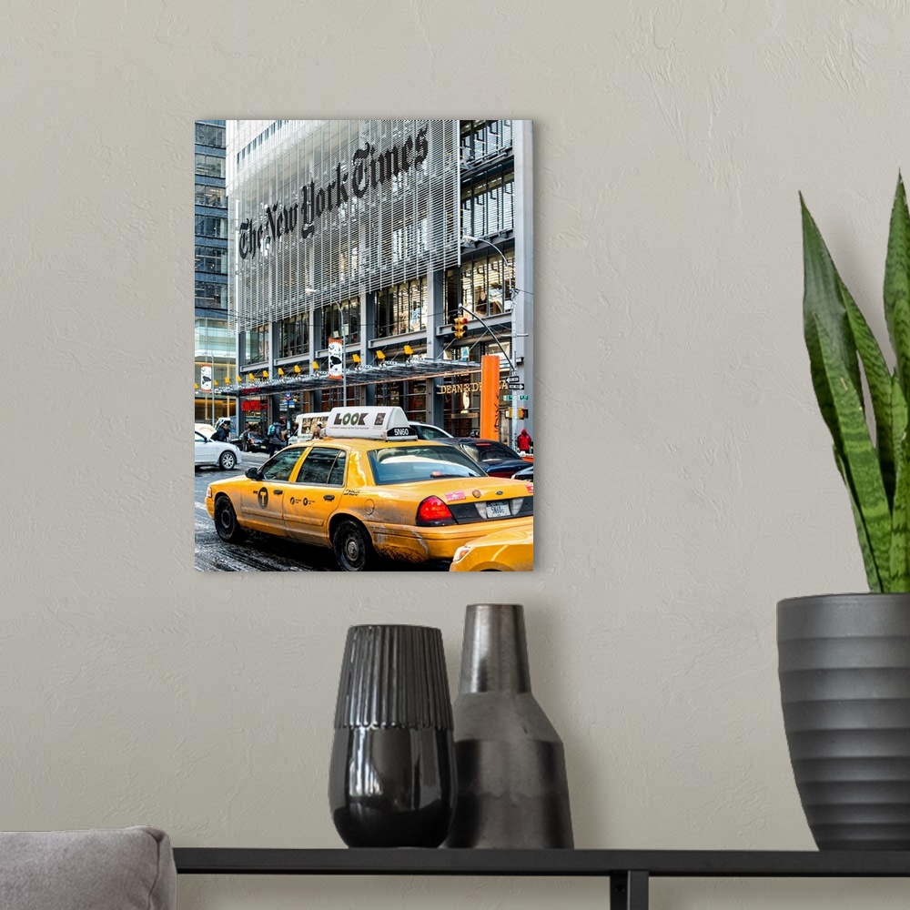 A modern room featuring A photograph of NYC taxi's in front of the New York Times building.