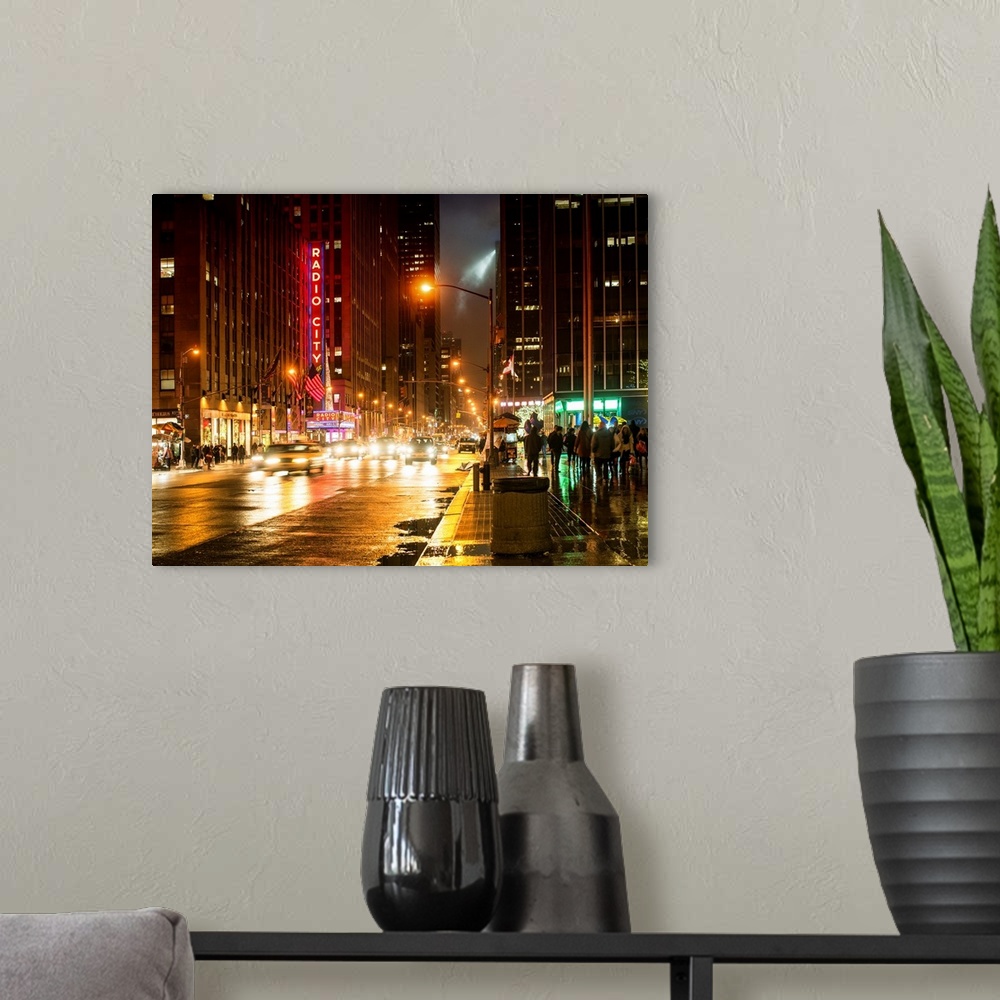 A modern room featuring Art photograph of New York city at night, with the Radio City sign lit up in neon.