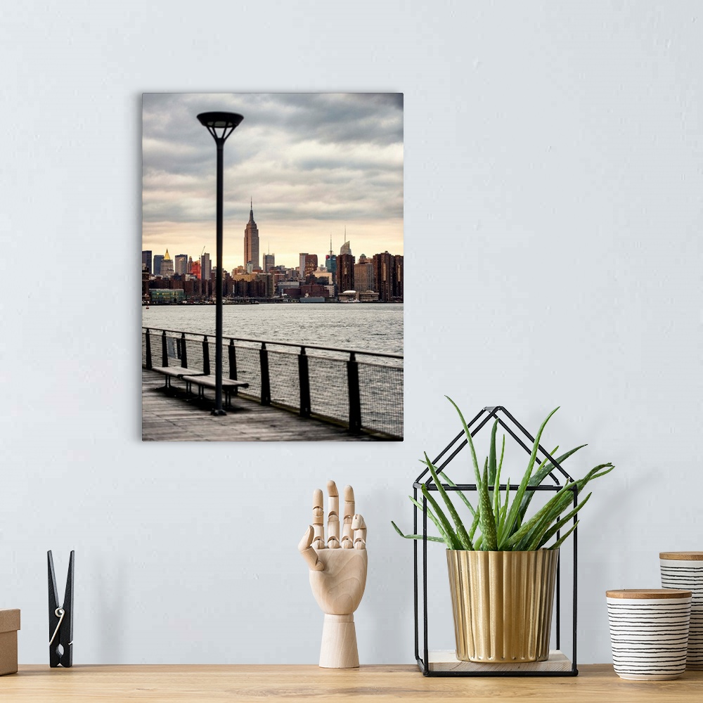 A bohemian room featuring A photograph of the Empire state building standing tall in NYC.