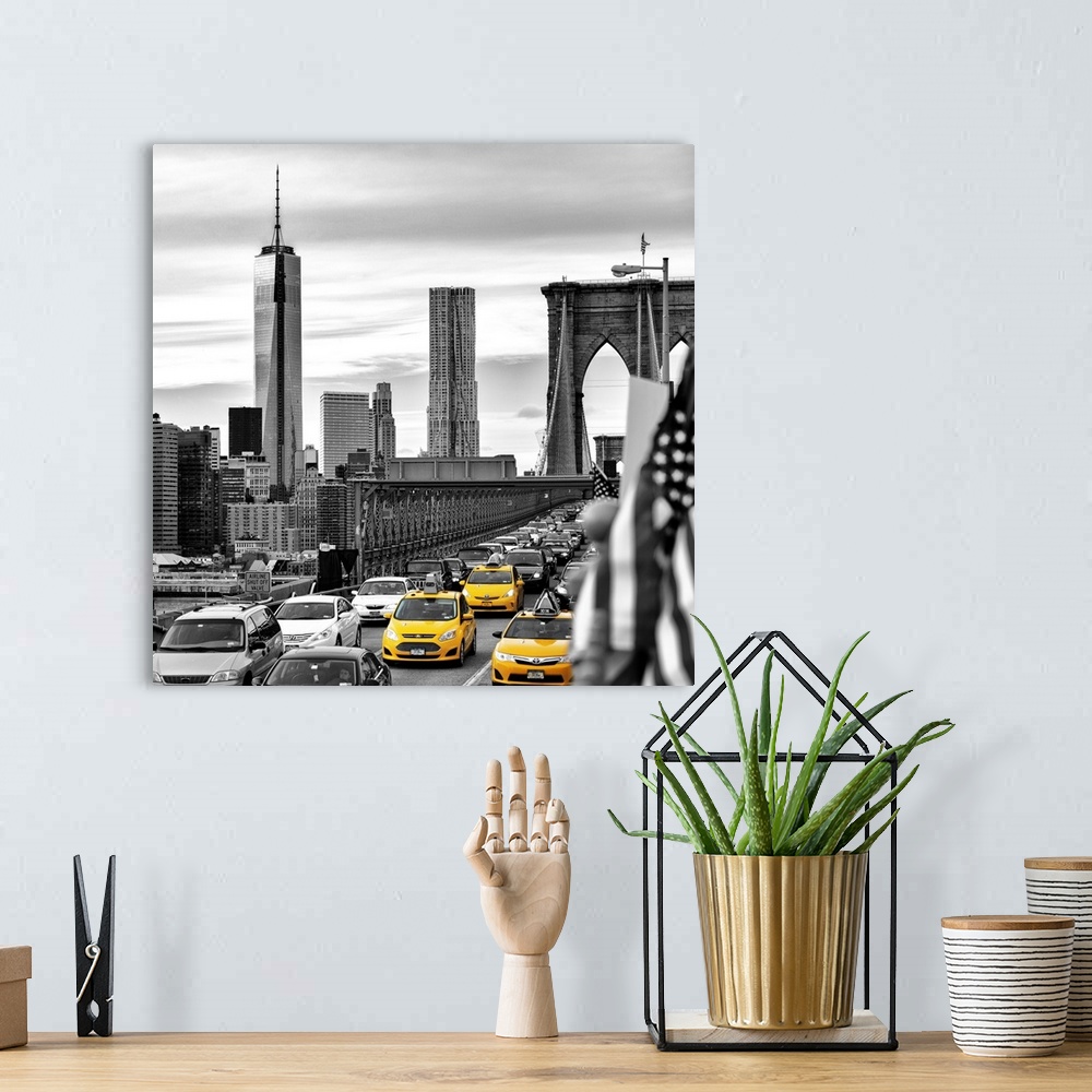A bohemian room featuring A black and white photograph of the One World Trade building from the Brooklyn bridge with yellow...