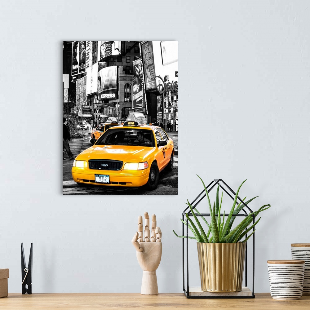 A bohemian room featuring A black and white photograph of New York city with a bright yellow taxi in focus.