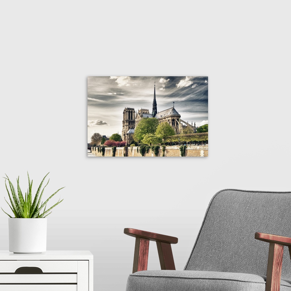 A modern room featuring Fine art photo of the Notre Dame Cathedral under a cloudy sky.