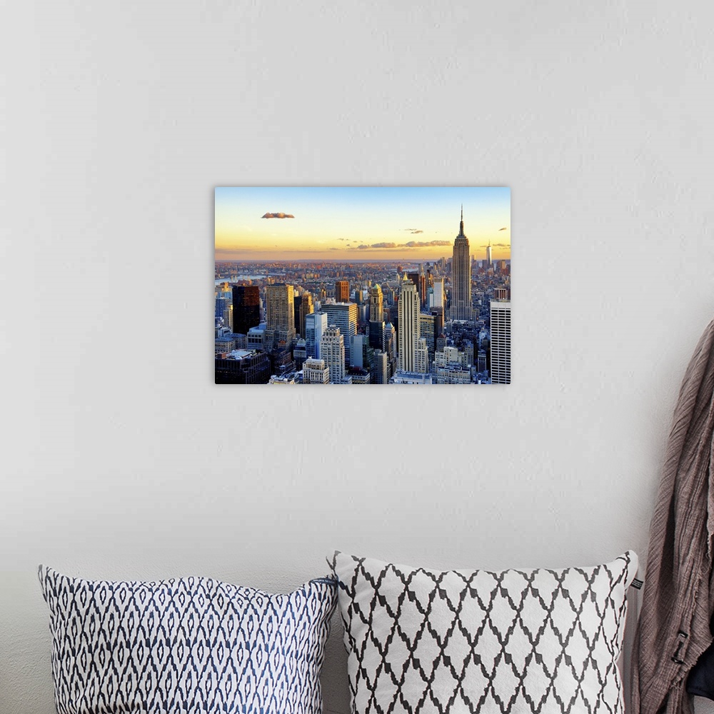 A bohemian room featuring Fine art photo of the New York City skyline at sunset, with the Empire State Building on the right.