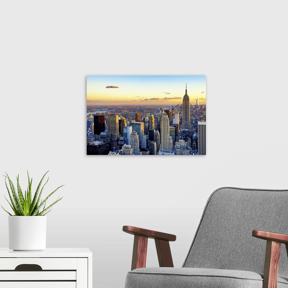 A modern room featuring Fine art photo of the New York City skyline at sunset, with the Empire State Building on the right.