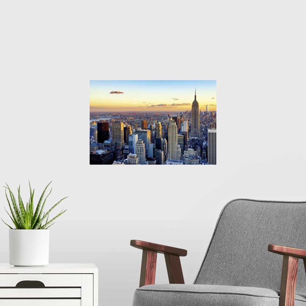 A modern room featuring Fine art photo of the New York City skyline at sunset, with the Empire State Building on the right.