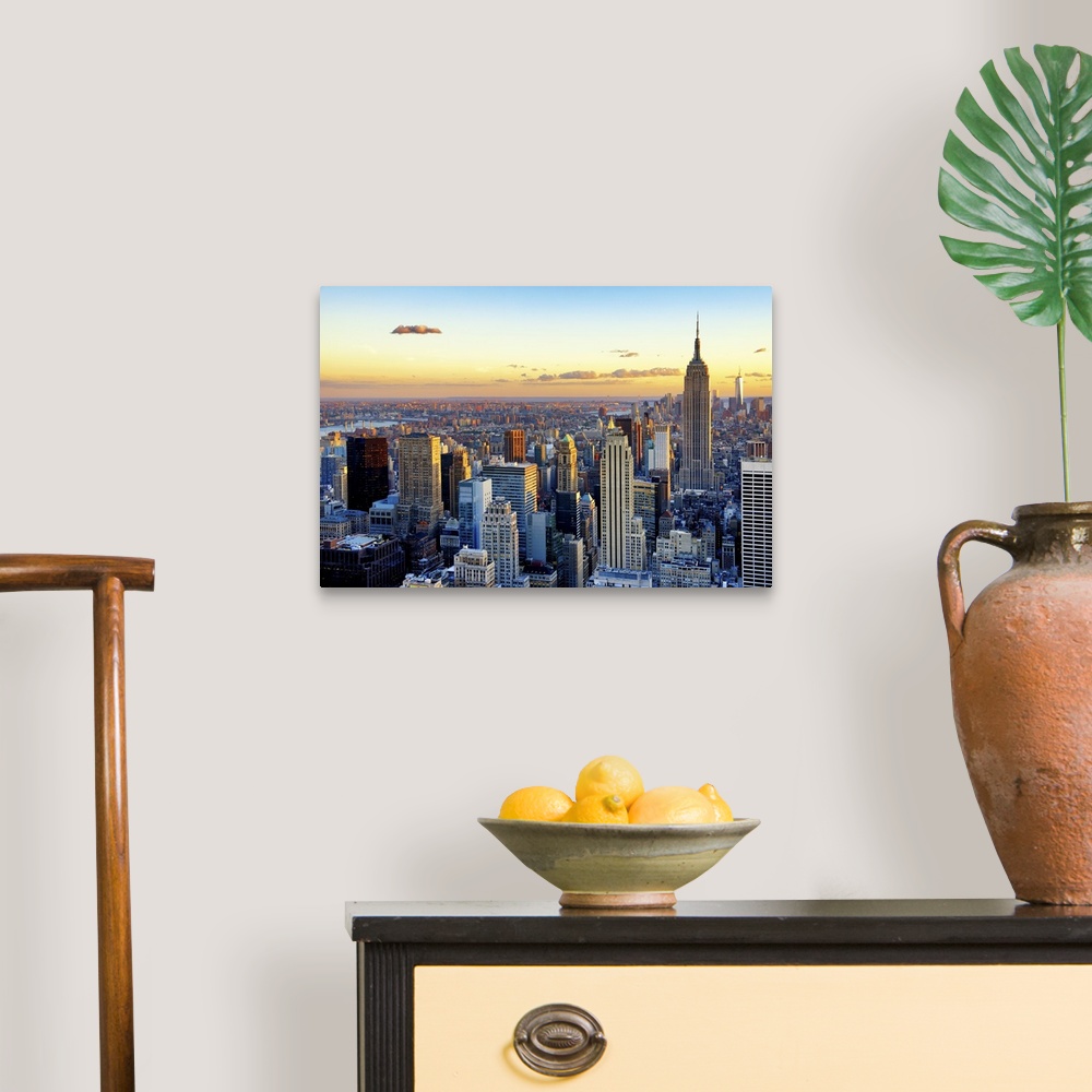 A traditional room featuring Fine art photo of the New York City skyline at sunset, with the Empire State Building on the right.