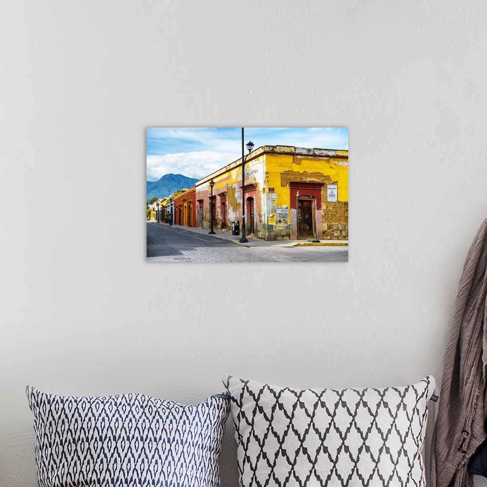A bohemian room featuring Photograph of a bright city street in Oaxaca, Mexico, with a view of mountains in the background....