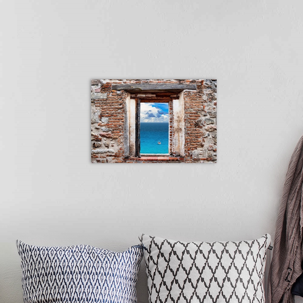 A bohemian room featuring View of a clear blue ocean with a boat framed through a stony, brick window. From the Viva Mexico...