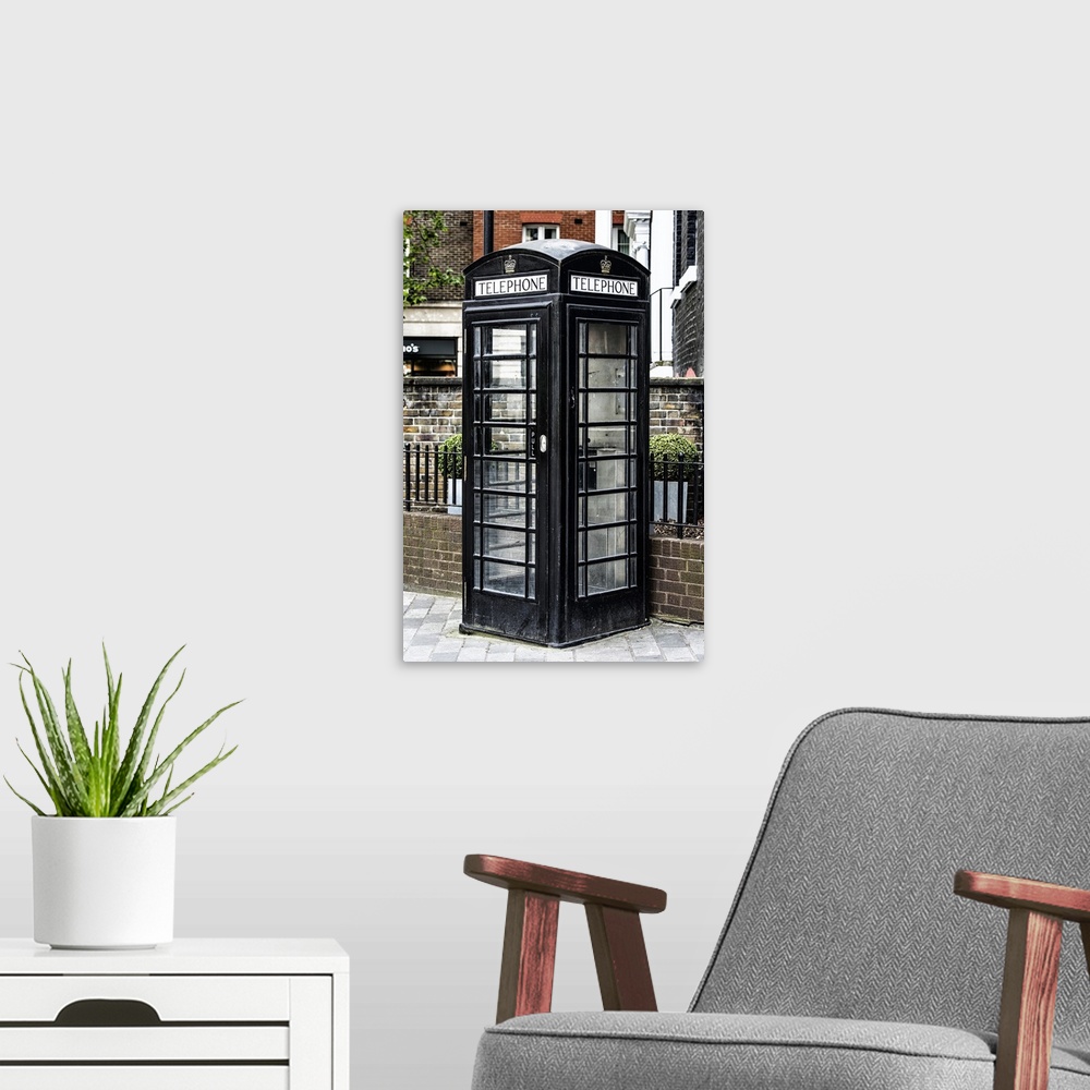 A modern room featuring Fine art photo of a London phone booth, unusually painted black.