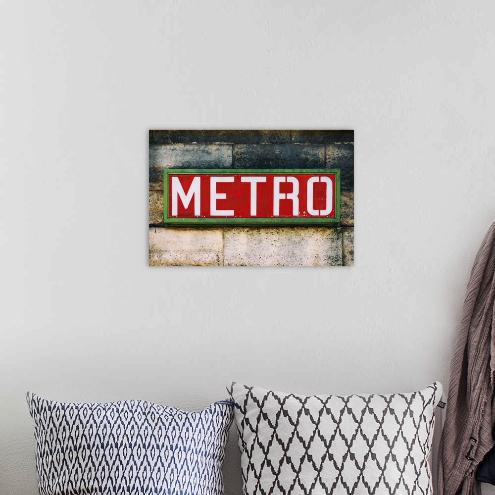 A bohemian room featuring Photograph of a Parisian sign against a stone wall.