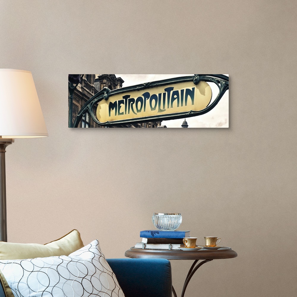 A traditional room featuring Sign for an entrance to a Paris Metro station, or subway.