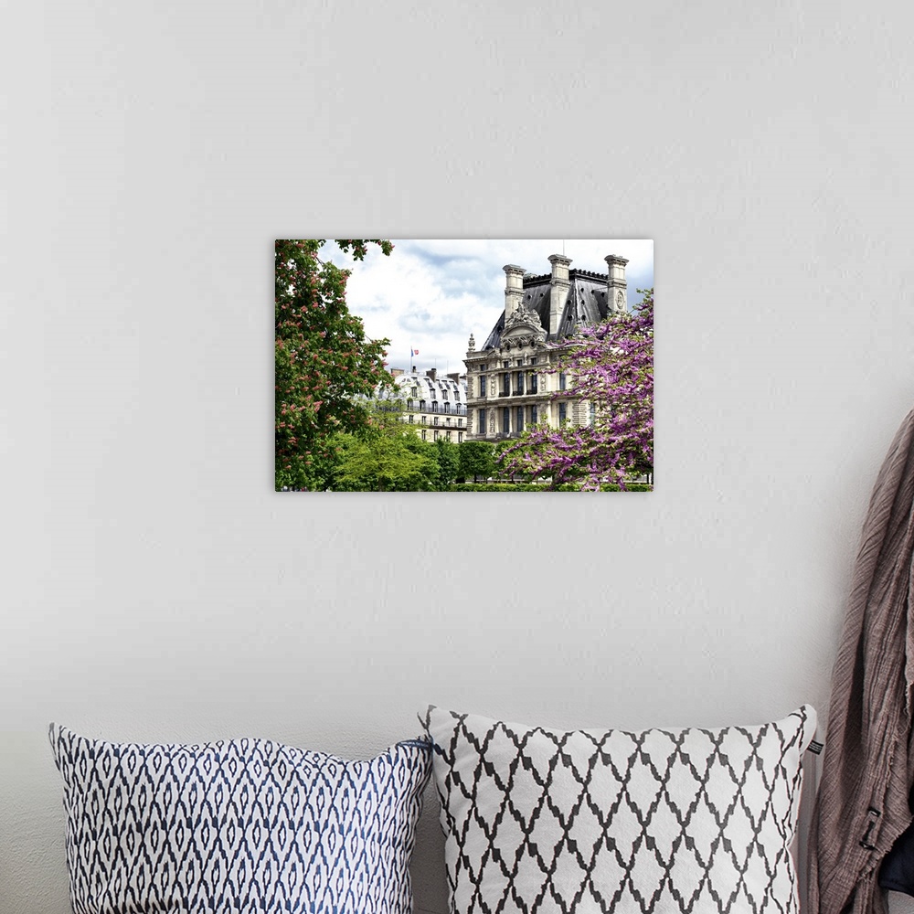 A bohemian room featuring Trees in full bloom frame classic French architecture on a beautiful spring day.