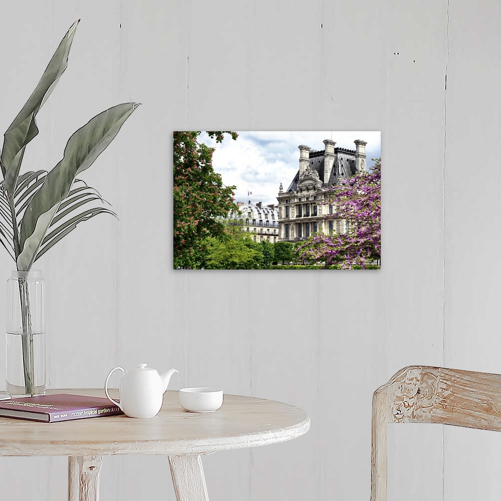 A farmhouse room featuring Trees in full bloom frame classic French architecture on a beautiful spring day.