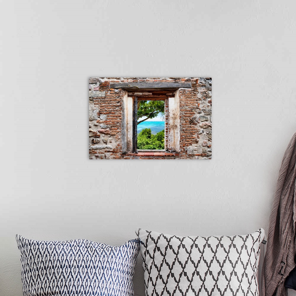 A bohemian room featuring View of Isla Mujeres, Mexico, framed through a stony, brick window. From the Viva Mexico Window V...
