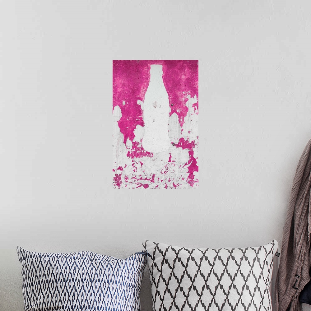 A bohemian room featuring Close-up photograph of a pink exterior wall with a white silhouette of a Coca Cola bottle painted...