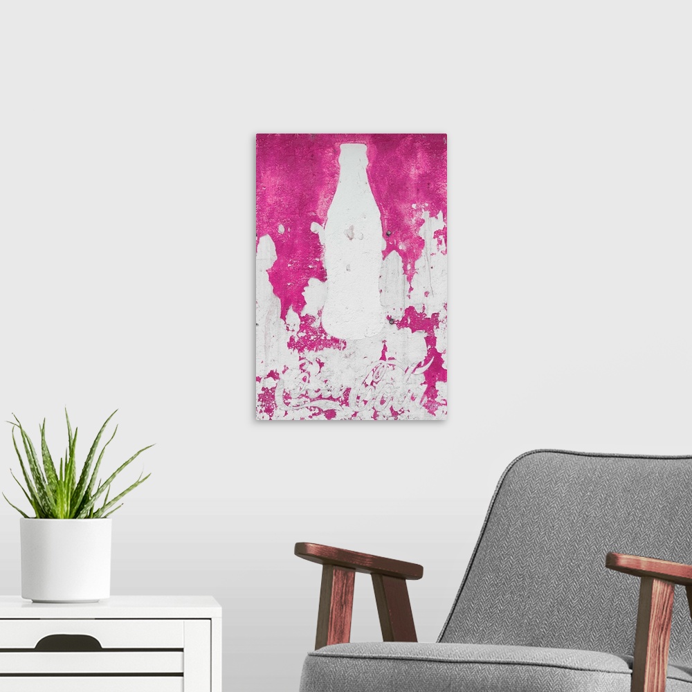 A modern room featuring Close-up photograph of a pink exterior wall with a white silhouette of a Coca Cola bottle painted...