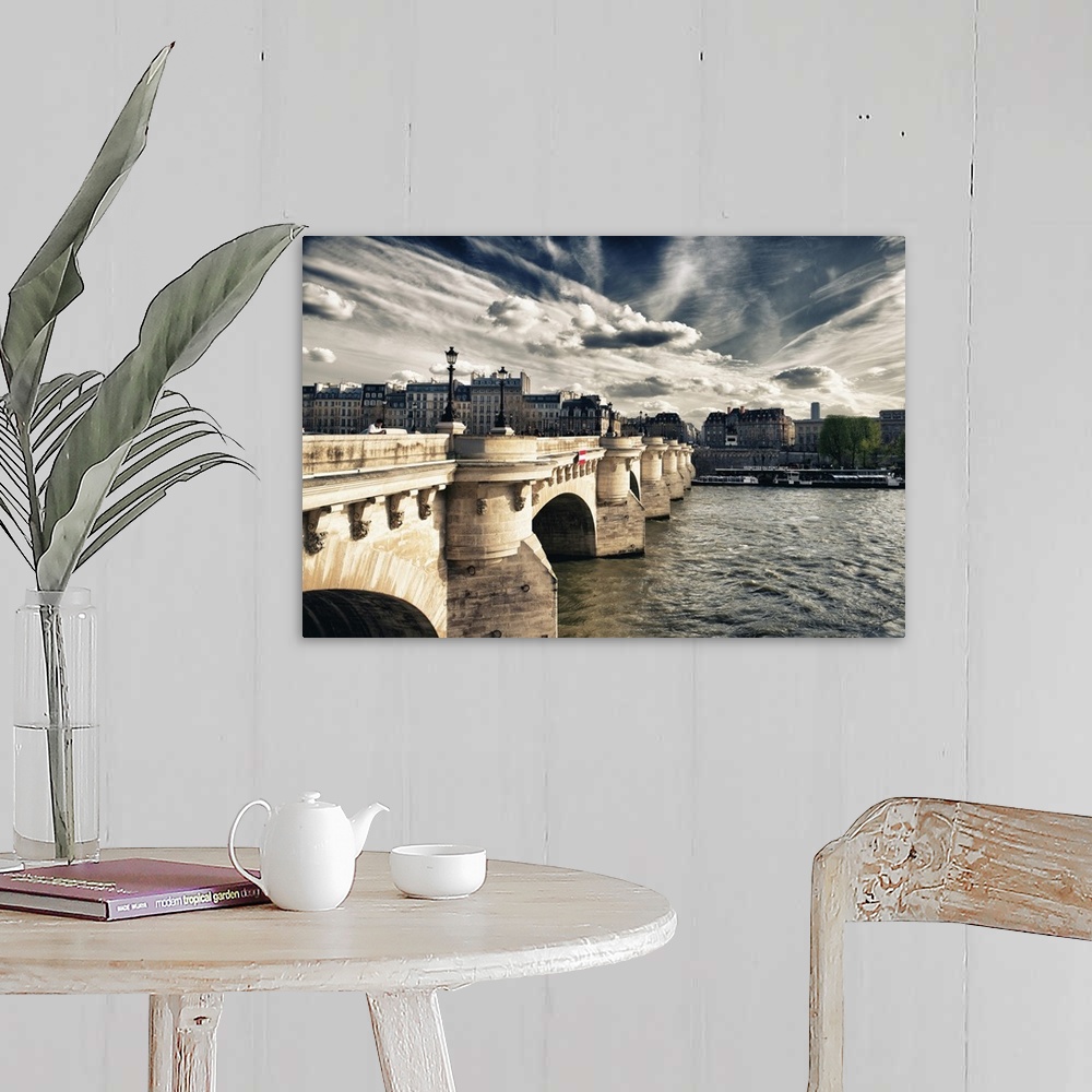 A farmhouse room featuring Arched bridge over the Seine River at sunset with stunning clouds in Paris, France.