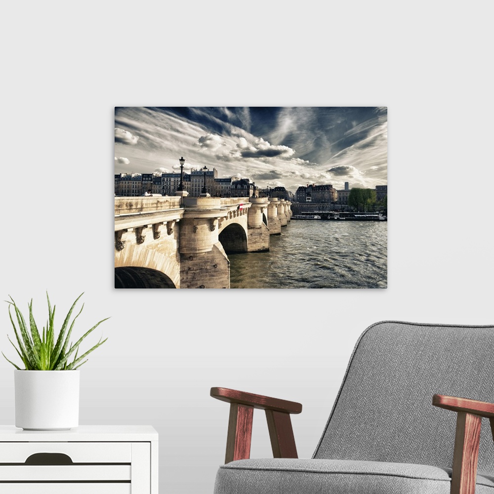 A modern room featuring Arched bridge over the Seine River at sunset with stunning clouds in Paris, France.