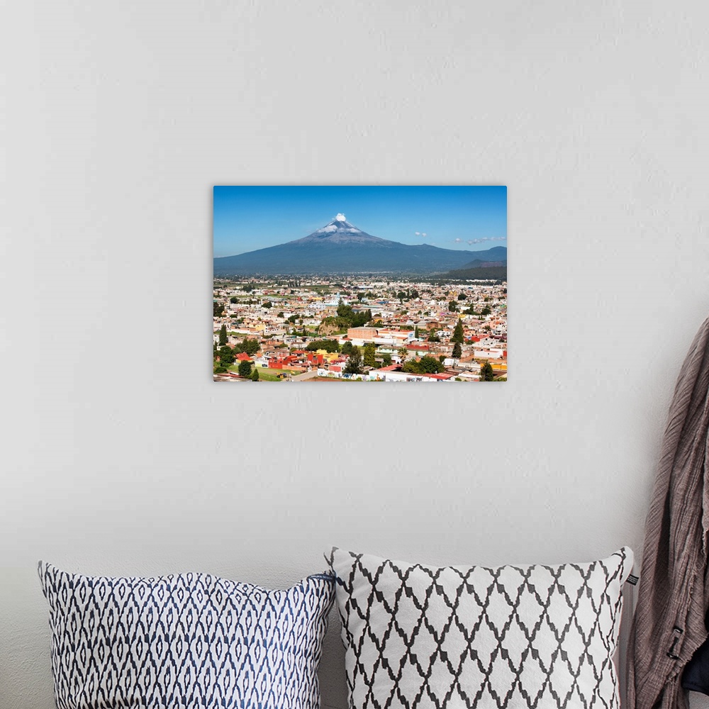 A bohemian room featuring Aerial photograph of the Popocatepetl Volcano in Puebla, Mexico, with a bird's eye view of the ci...