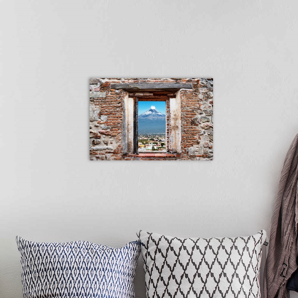 A bohemian room featuring View of the Popocatepetl Volcano in Puebla, Mexico, framed through a stony, brick window. From th...