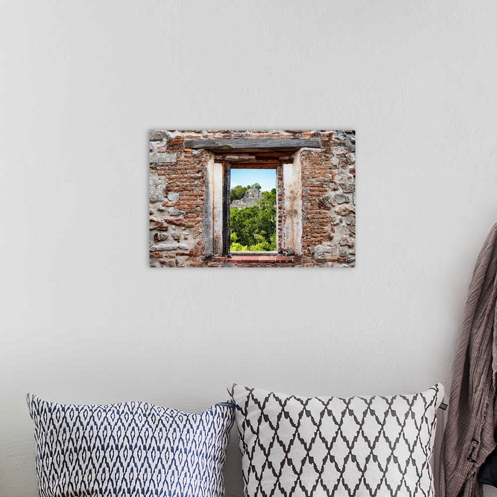 A bohemian room featuring View of the Mayan Pyramid in the city of Calakmul, Mexico,  framed through a stony, brick window....