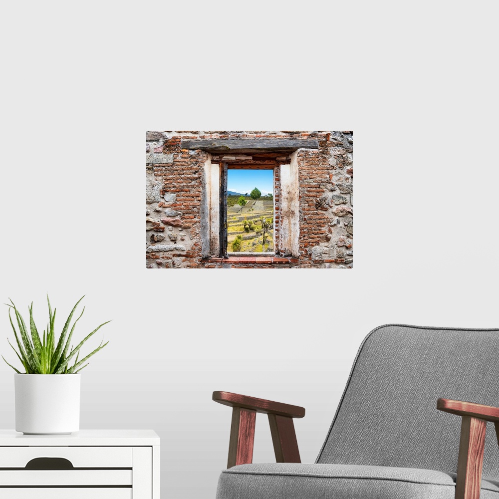 A modern room featuring View of the Pyramid of Cantona, Mexico, framed through a stony, brick window. From the Viva Mexic...