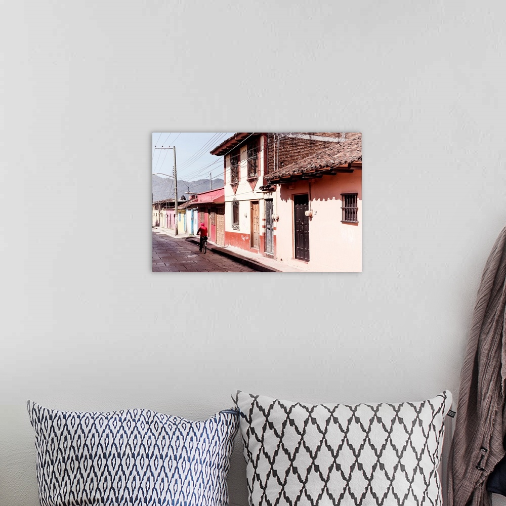 A bohemian room featuring Photograph of a streetscape in Mexico with a man in red riding a bike down the road. From the Viv...